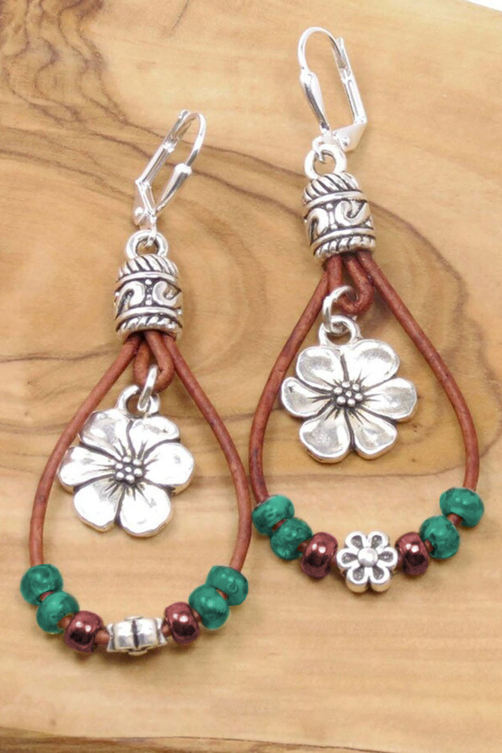 Floral dangle earrings, silvery leather.